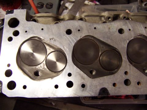 1971 Ford Mustang - Close-up view of an engine cylinder head, showing the valve openings and surrounding metal.