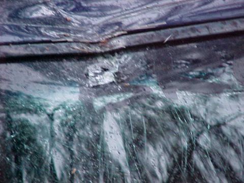 1995 Ford Bronco - Vehicle damage includes a crumpled body panel and broken windshield.