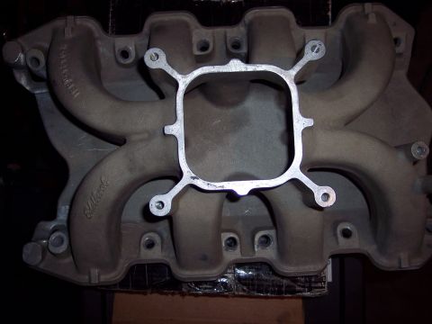 1971 Ford Mustang - An aluminum intake manifold with a square opening and four intake runners is shown.