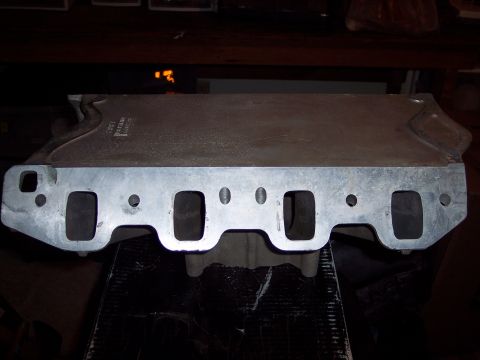 1971 Ford Mustang - An aluminum intake manifold is shown from the side, revealing its exhaust ports.