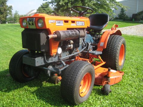 1993 Ford Probe - A four-wheel drive Kubota tractor, model B7100, sits on a grassy lawn.