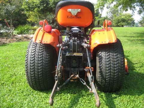 1993 Ford Probe - This orange tractor features large rear tires and the name "Keller Bros." visible on the seat.