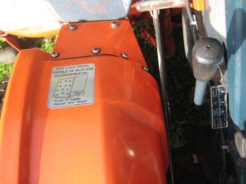 1993 Ford Probe - Close-up of tractor controls, including a diff lock pedal label and a gear shift lever.