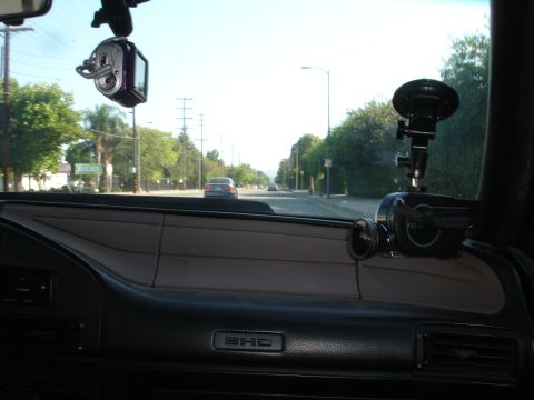 1993 Ford Taurus - View from inside a car, looking out at a street scene with trees and other vehicles.
