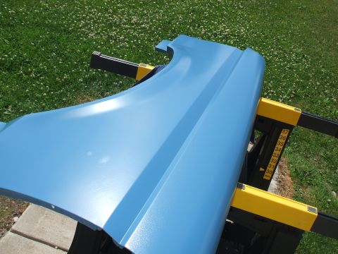 1990 Ford Bronco - A light blue fender is supported by sawhorses on a grassy area.