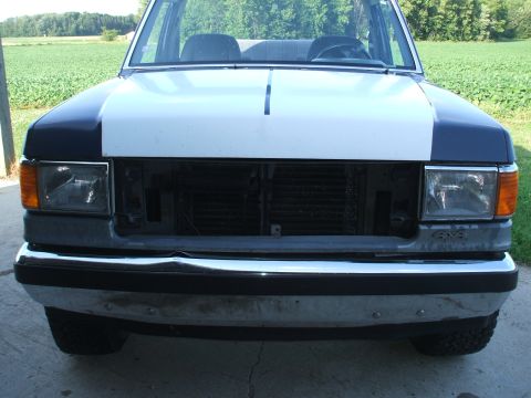 1990 Ford Bronco - Front view of a 1990 Ford Bronco with the grille removed to expose the radiator.