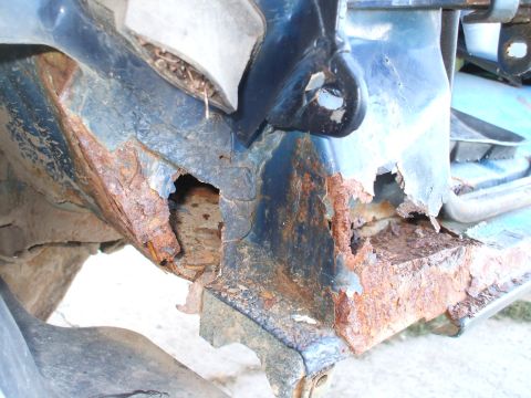 1990 Ford Bronco - Significant rust damage is visible on the vehicle's structural components.