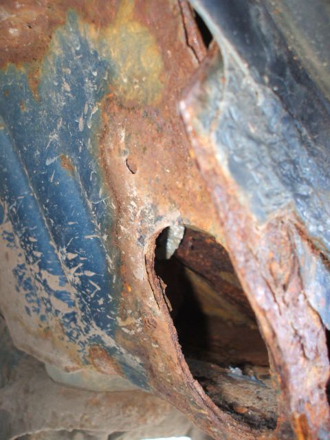 1990 Ford Bronco - This image shows significant rust damage to a vehicle's frame, making year identification impossible.