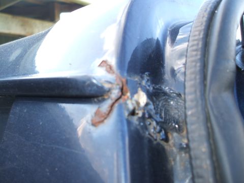 1990 Ford Bronco - Rust damage is visible on the door frame of this vehicle.