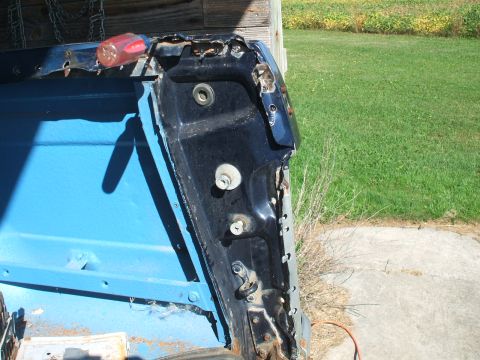1990 Ford Bronco - Close-up of a rusted door frame interior, showing blue painted metal and a screwdriver.