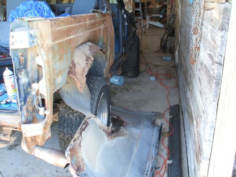 1990 Ford Bronco - Vehicle body panel in severe disrepair, likely undergoing restoration or salvage.