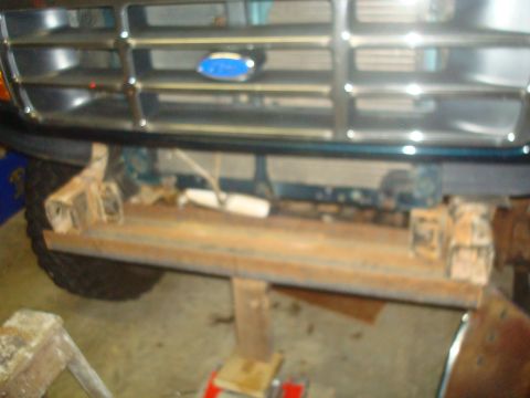 1995 Ford Bronco - Front view of a 1992 Ford Bronco's grille and bumper area, showing a rusty bumper mount.