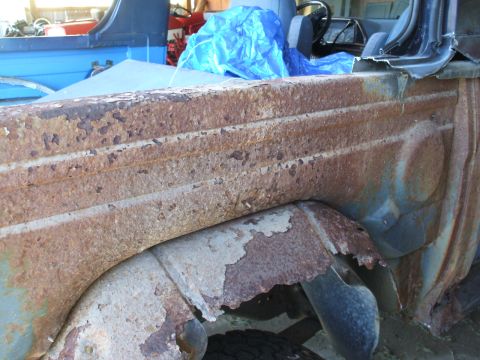 1990 Ford Bronco - The extensive rust on the rear quarter panel and wheel well indicates significant deterioration.