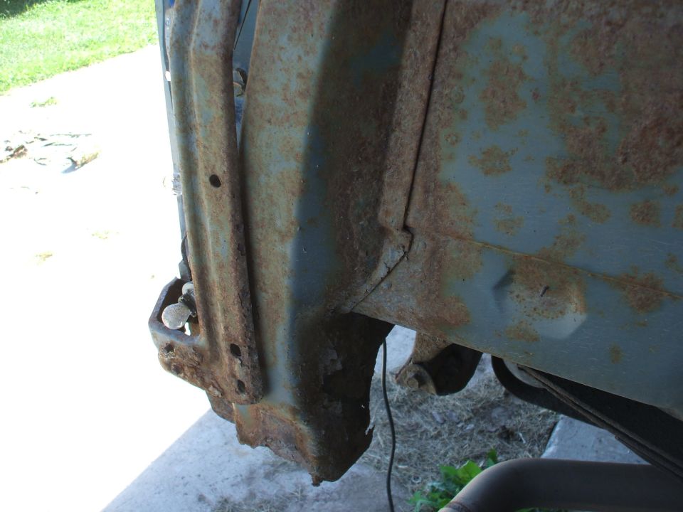 rusted metal fender well with visible bolts and mounting points