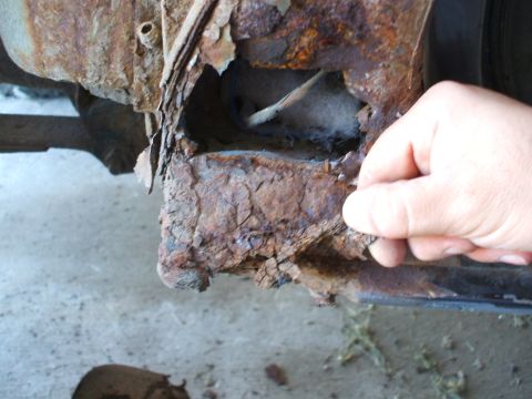 1990 Ford Bronco - Severe rust damage is visible on the vehicle's frame, indicating significant deterioration.