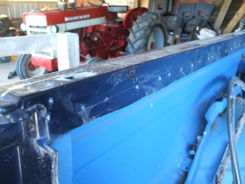 1990 Ford Bronco - The interior of a vehicle is shown, with a red tractor visible in the background.