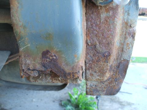 1990 Ford Bronco - Severe rust damage is visible on the seam of a vehicle's metal panel.
