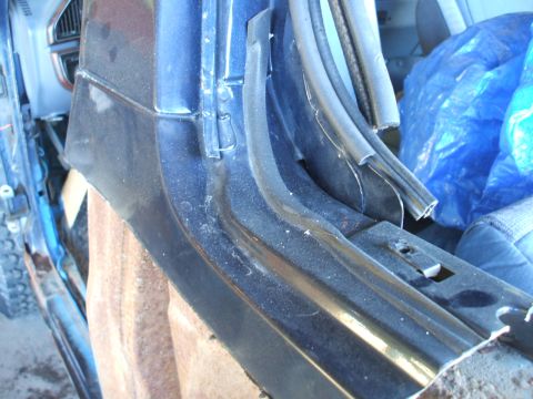 1990 Ford Bronco - Interior door jamb area with weather stripping and part of a seat visible.