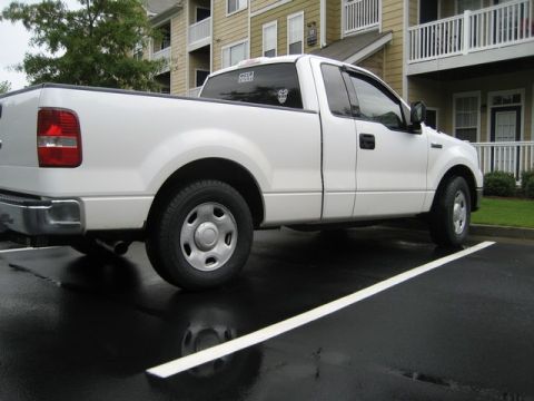 2004 Ford F-150 - Side view of a white 2004 Ford F-150 pickup truck parked in a lot.