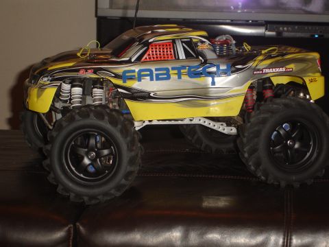 1989 Ford Bronco - This remote control monster truck features a yellow and silver paint scheme with Fabtech branding.