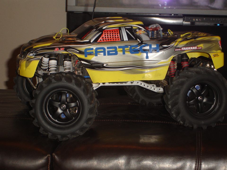 Yellow and silver remote control monster truck with Fabtech graphics