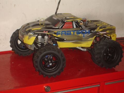 1989 Ford Bronco - This remote control monster truck features a yellow and black paint scheme with "FABTECH" branding and large off-road tires.