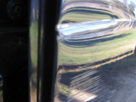 2005 Ford F-150 - Close-up of a truck door, showing distorted reflections of the surrounding environment.