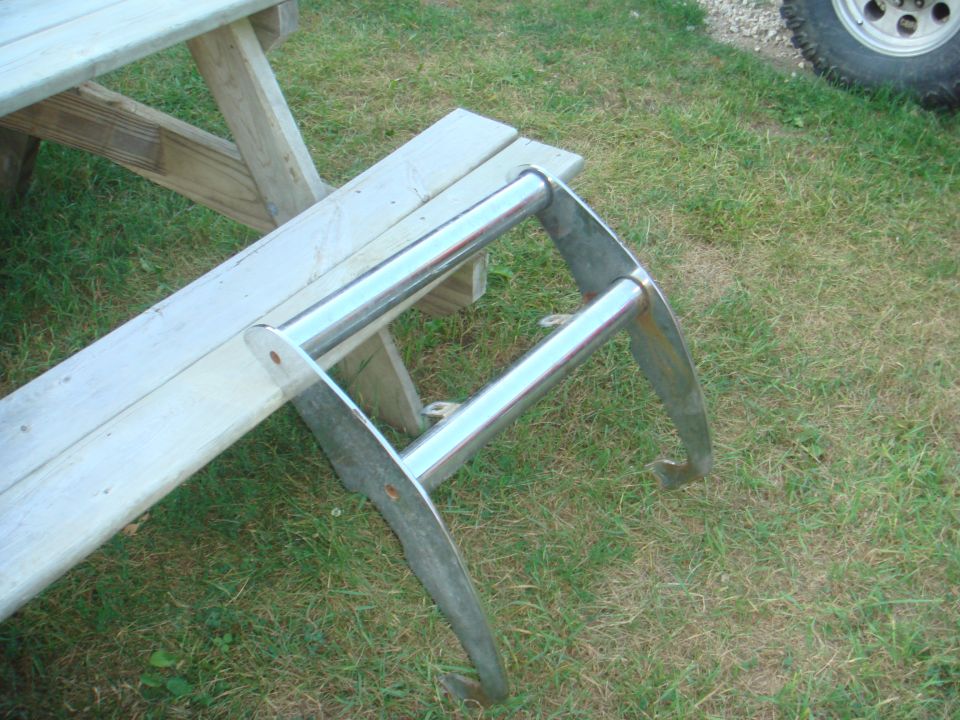 Chrome bull bar resting on a wooden picnic table bench