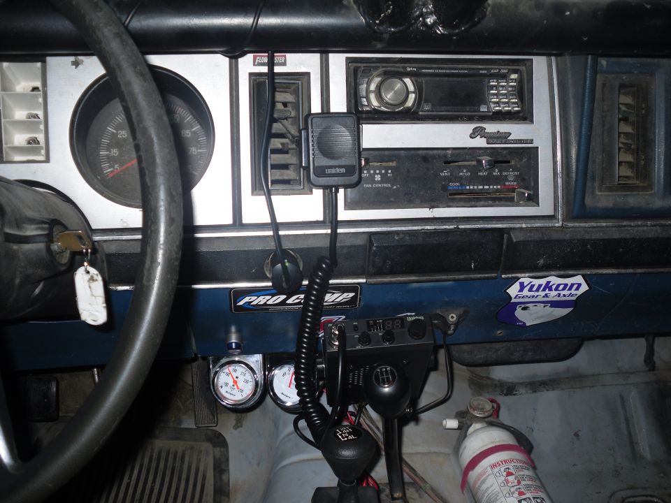 1984 Ford Bronco II interior showing dashboard, steering wheel, gauges, radio, and CB. Pro Comp sticker visible