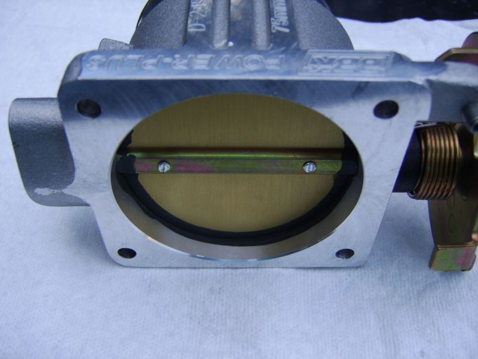Some reference pictures -

The black coating is used to improve the seal between the throttle body bore and blade, this improves idle quality.

I gave the exterior of the T/B including linkage a couple coats of Eastwood clear for bare metal so it wouldn't get oxidized and discolored by next year :D