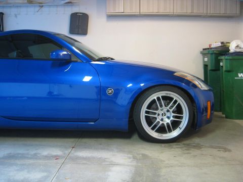 1990 Ford Probe - A blue coupe is parked in a garage, showing its side profile and front wheel.