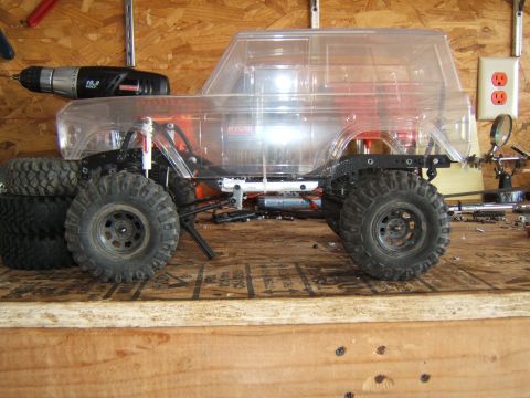 1988 Ford Bronco - This RC crawler features a clear plastic body, revealing the internal chassis and suspension components.
