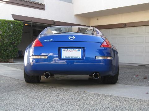 1990 Ford Probe - Rear view of a blue Nissan 350Z parked in a driveway.