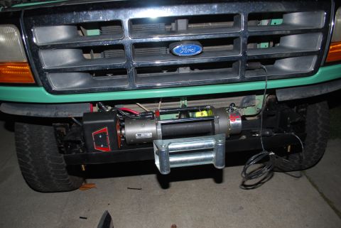 1996 Ford Bronco - The front grille and bumper of a green Ford Bronco are visible, equipped with a winch.