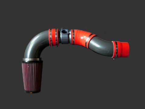2004 Subaru Impreza - Aftermarket intake pipe assembly with K&N air filter and red silicone couplers.