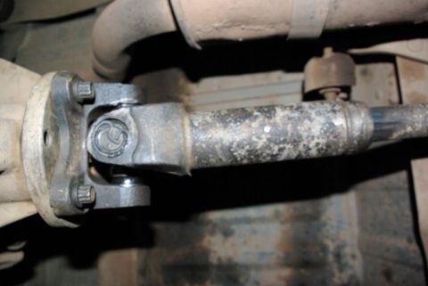 1995 Ford Bronco - Close-up view of a vehicle's driveshaft u-joint, showing the connection points and hardware.
