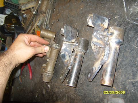 1989 Ford Bronco - Several metal components, some showing welding, are laid out on a cluttered surface.