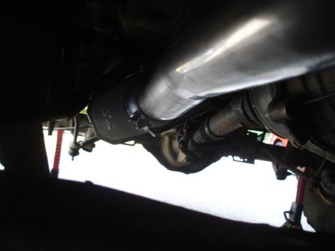 1995 Ford Bronco - Close-up of the vehicle's undercarriage, focusing on the exhaust components and rear axle.
