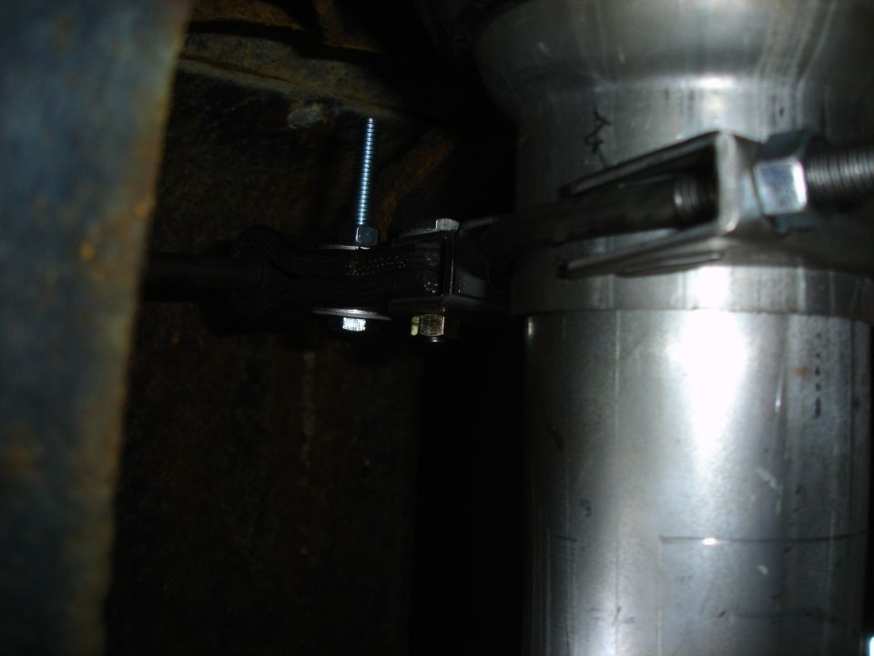 Close-up of suspension bushing and bolt under a vehicle