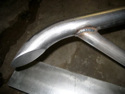 1996 Ford Bronco - A close-up view of a metal tube bumper part, showing its construction and finish.