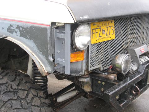 1990 Ford F-250 - This heavily modified truck features off-road tires, a winch, and an Alaska license plate.