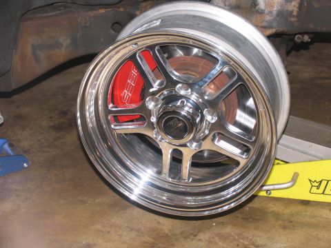 1990 Chevrolet Silverado 1500 - Close-up of a chrome wheel with a red brake caliper visible through the spokes.