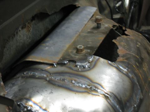 1993 Ford Bronco - Close-up view of a damaged and repaired vehicle frame section.