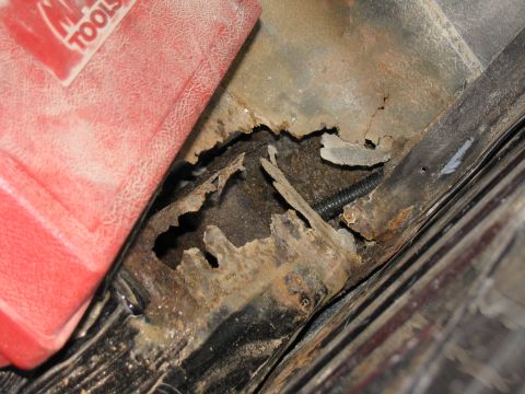 1993 Ford Bronco - Significant rust damage is visible on the vehicle's frame, with a red toolbox in the upper left corner.