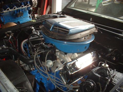 1970 Ford Torino - Close-up view of a V8 engine, a blue air cleaner and chrome valve covers.