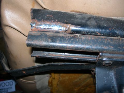 1984 Ford Bronco - Close-up view of a seat bracket showing signs of rust and welding repairs.