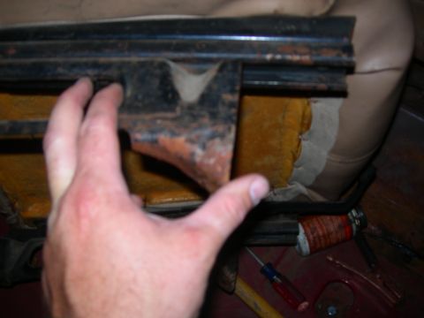 1984 Ford Bronco - Close-up of a vehicle's seat rail mechanism, showing signs of wear and rust.