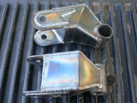 1988 Ford Bronco - Two custom fabricated suspension parts are shown, likely for an off-road vehicle modification.