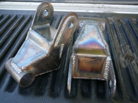 1988 Ford Bronco - Pair of custom-fabricated metal brackets, likely for automotive suspension or mounting.