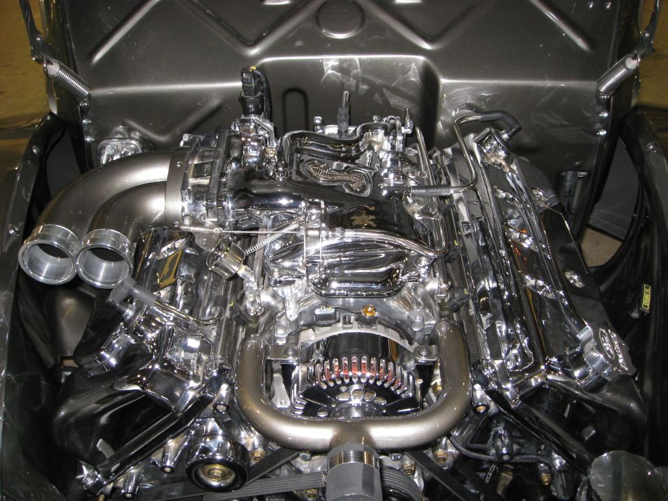 highly polished V8 engine with dual exhaust pipes and chrome components